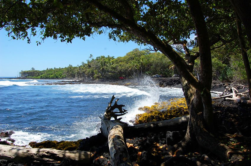 Waves crash against lava rocks