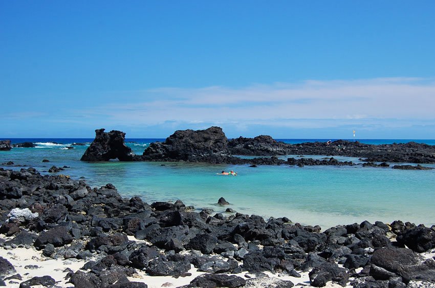 Black rocks in the white sand