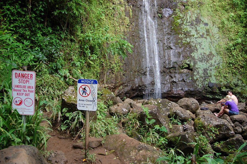 People sitting in a rockfall danger area