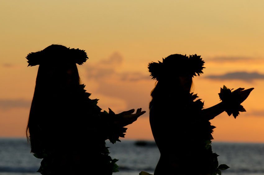 Two hula dancers at sunset