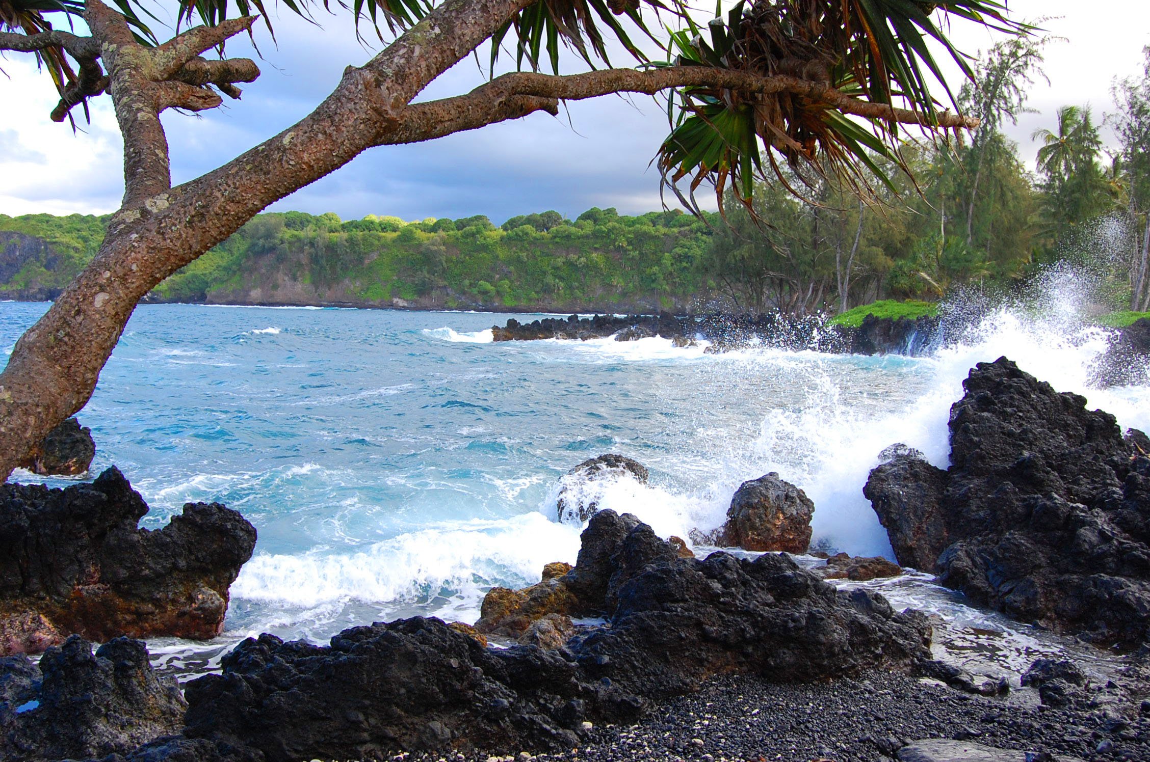 Waves splash onto lava rocks on Maui