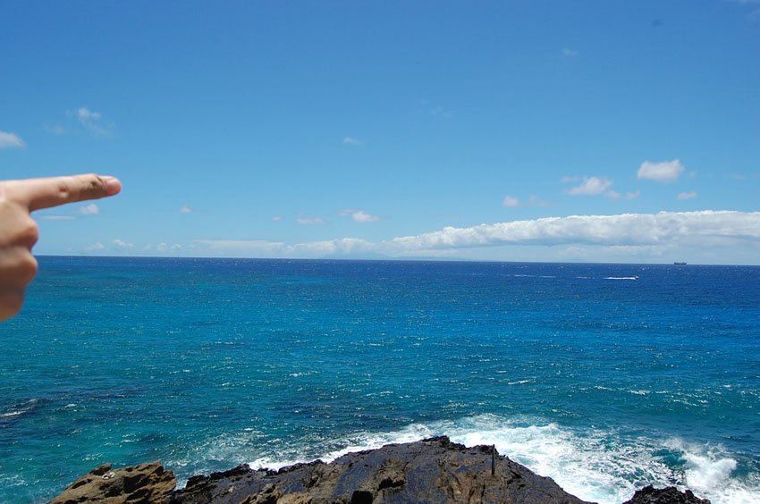 Pointing to Island of Lanai on the horizon